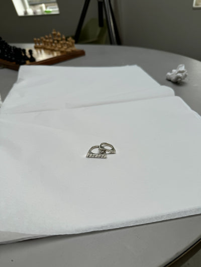 Nahaufnahme von zwei personalisierten Ringen aus recyceltem Silber, die individuelle Schriftzüge tragen und in Handarbeit in Hamburg gefertigt wurden.