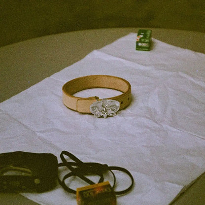 ein closeup von dem orchideen gürtel. hirbei handelt es sich um eine einzelanfertigung, eines der spezialgebiete von zweisilber. 